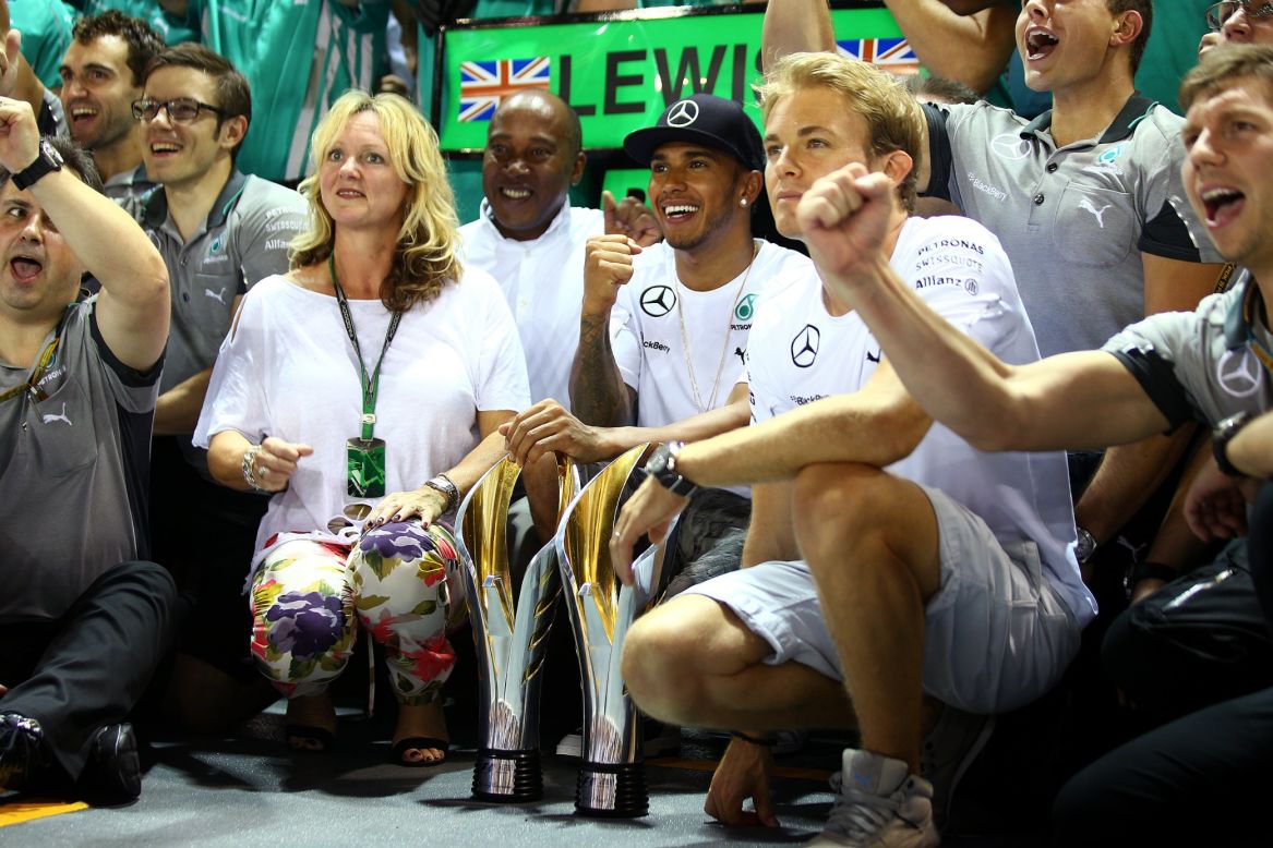Round 14: Rosberg joins Hamilton and his family for the celebrations in Singapore but another win for the Briton means Rosberg loses his championship lead.