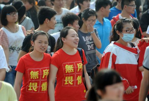 Two students  wearing t-shirts saying "fear nothing" walk into the exam room to sit the 2014 college entrance exam in China, or the 'gaokao', in Bozhou, east China's Anhui province. The "gaokao" can make the difference between a prestigious university in Beijing or relegation to a regional college.