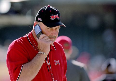 Aside from flip phones, few things say "early 2000s" like the XFL. In this 2001 image, football legend Dick Butkus, the short-lived league's Director of Football Competition, growls (we're guessing) into his flip phone.