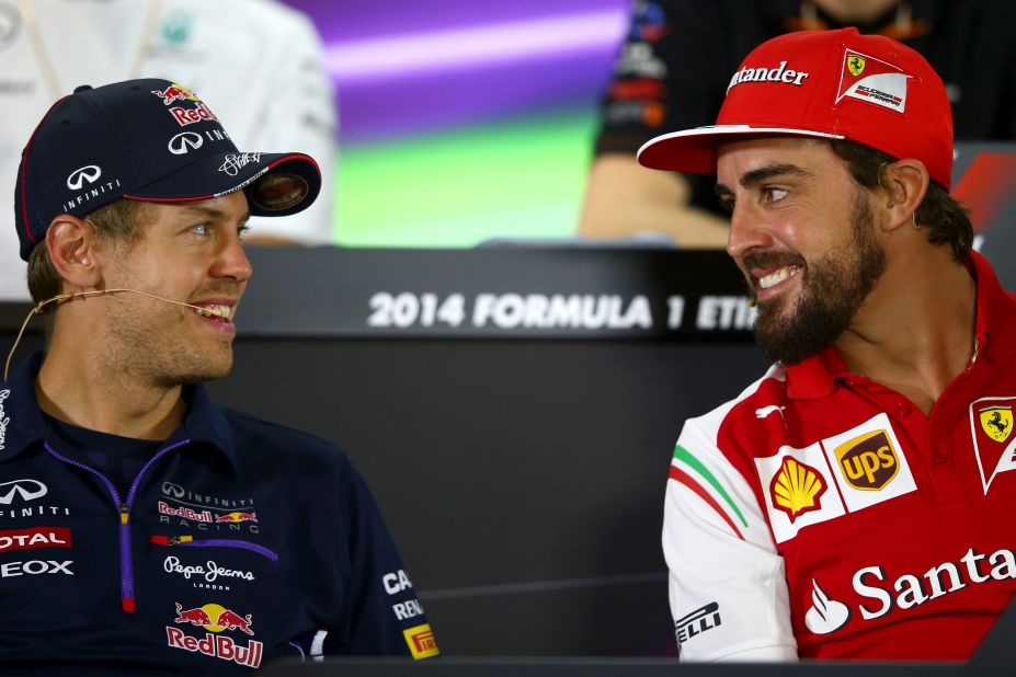 Swapping sides: Fernando Alonso (right) is leaving Ferrari but he will be replaced in 2015 by Red Bull's four-time world champion Sebastian Vettel (left).