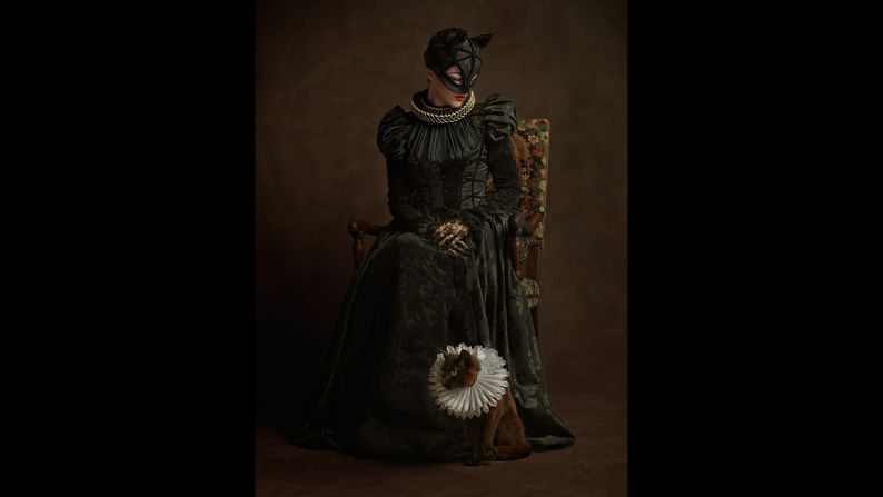 The portraits also emphasize the humanity behind the characters. Here's Catwoman, complete with live cat.