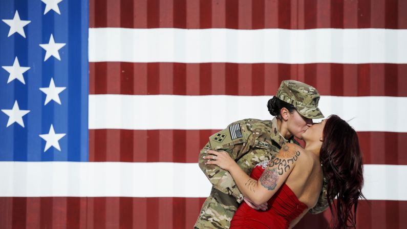 U.S. Army Spc. Sabryna Schlagetter kisses her wife, Cheyenne, after returning home to Fort Carson, Colorado, with other members of the 4th Infantry Brigade Combat Team on Friday, November 14. The couple married on Valentine's Day this year before Sabryna deployed to Afghanistan.