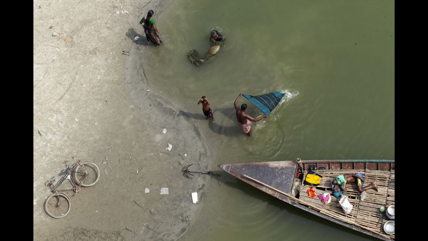 People in Dhaka, Bangladesh, spend time in a dried-up bed of the Kaliganga River on Monday, November 17.