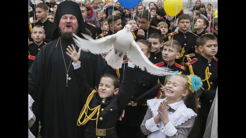 A young military cadet releases a pigeon after an oath-taking ceremony Friday, November 14, at a monastery in Kiev, Ukraine.