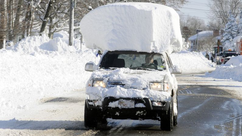 A vehicle with a large chunk of snow on its roof drives along Route 20 after a massive snowfall in Lancaster, New York, on Wednesday, November 19. A ferocious storm dumped large piles of snow on parts of upstate New York, trapping residents in their homes and stranding motorists on roadways, as snowstorms and record-low temperatures <a href="http://www.cnn.com/2014/11/19/us/gallery/wintry-weather/index.html">hit much of the country.</a>