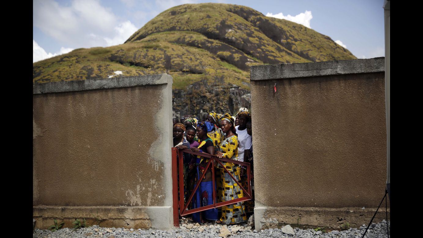 Residents of Macenta, Guinea, watch the inauguration of an Ebola treatment center there Friday, November 14. The <a href="http://www.cnn.com/2014/04/04/world/gallery/ebola-in-west-africa/index.html">Ebola outbreak in West Africa</a> has killed more than 5,400 people, according to the World Health Organization.