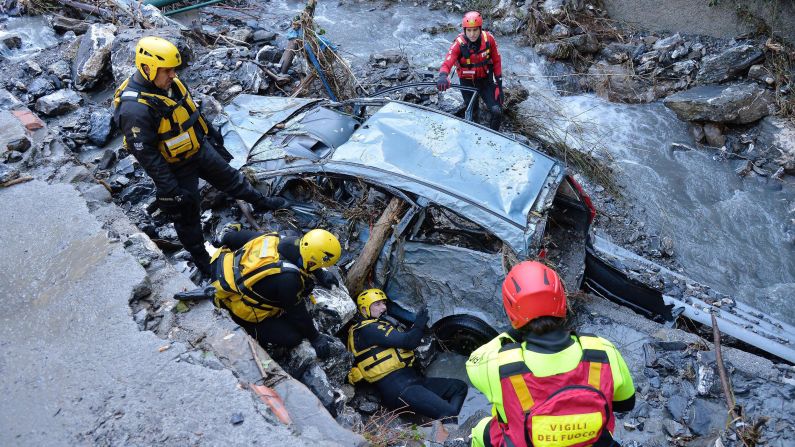 Rescuers look for a missing person in Serra Ricco, Italy, after a wave of storms and torrential rain hit northern Italy on Sunday, November 16.