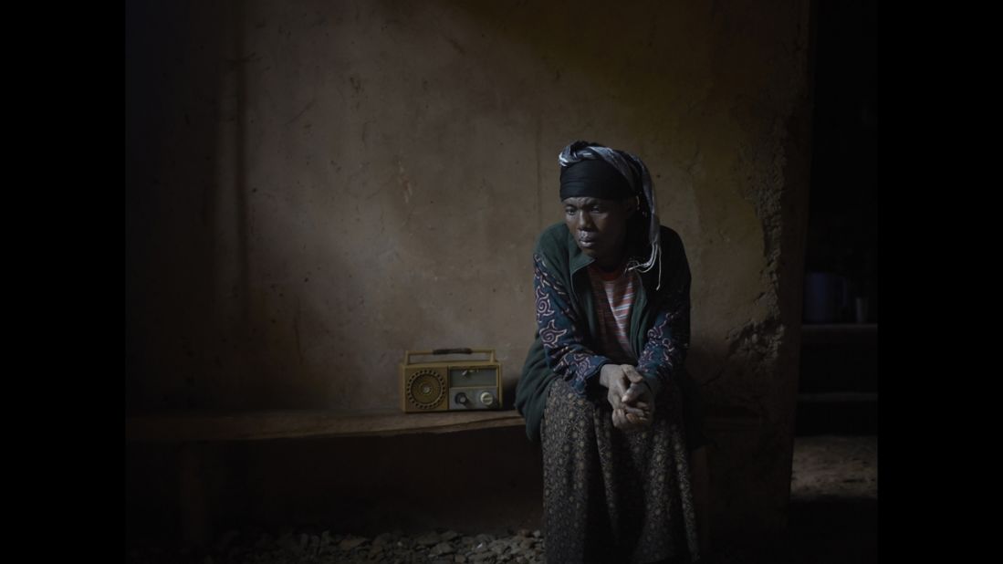 A woman in Rwanda listens to "Musekeweya."