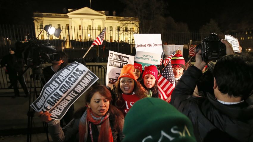 People chant during a demonstration in front of the White House in Washington, Thursday, Nov. 20, 2014, as President Barack Obama announced executive actions on immigration during a nationally televised address.