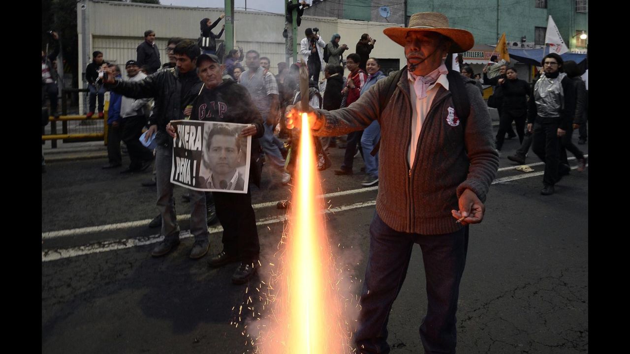 A protester lights a firework as demonstrators march on November 20.