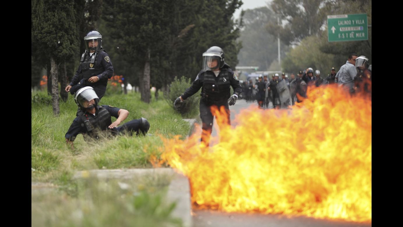 A police officer falls after a protester threw a Molotov cocktail on November 20.