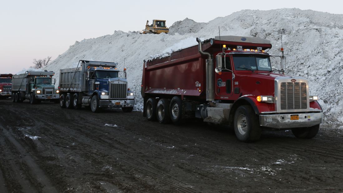 Dump trucks wait to unload snow that was removed from south Buffalo, New York, neighborhoods on November 21.  