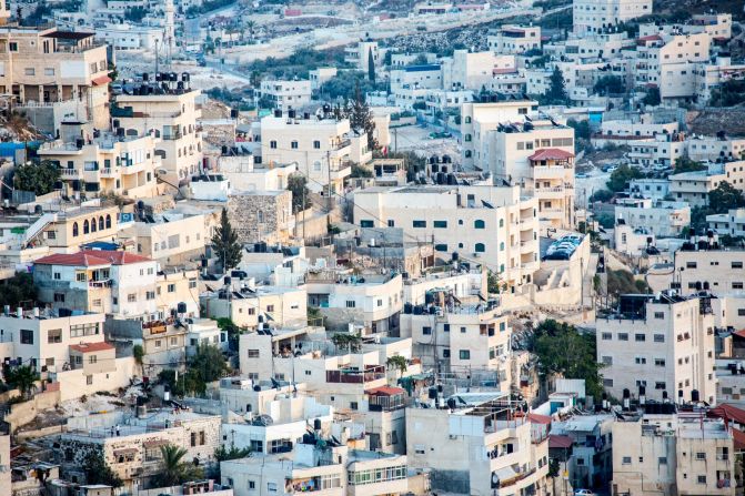 Cascades of white buildings seemingly flow along the hills of Jerusalem. 