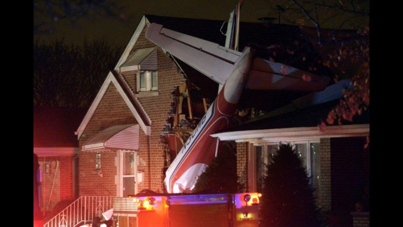 A twin-engine cargo plane is seen after crashing into a Chicago house shortly after taking off from Midway International Airport on Tuesday, November 18. The pilot, who reported engine problems prior to the crash, was killed. The plane narrowly missed a couple sleeping in the house. 