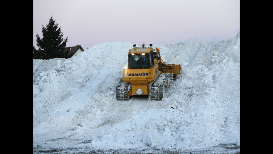 Heavy equipment moves snow at the Central Terminal that was removed from south Buffalo neighborhoods on Friday, November 21, after heavy lake-effect snowstorms.  