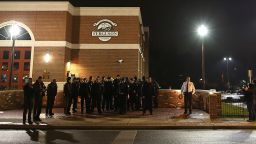 FERGUSON, MO - NOVEMBER 21: Police gather in front of the Ferguson fire station as demonstrators protest the shooting death of 18-year-old Michael Brown on November 21, 2014 in Ferguson, Missouri. Brown, who was black, was killed by Darren Wilson, a white Ferguson, Missouri police officer, on August 9. Tensions remain high as a grand jury is expected to decide soon if Wilson should be charged in the shooting. (Photo by Justin Sullivan/Getty Images)
