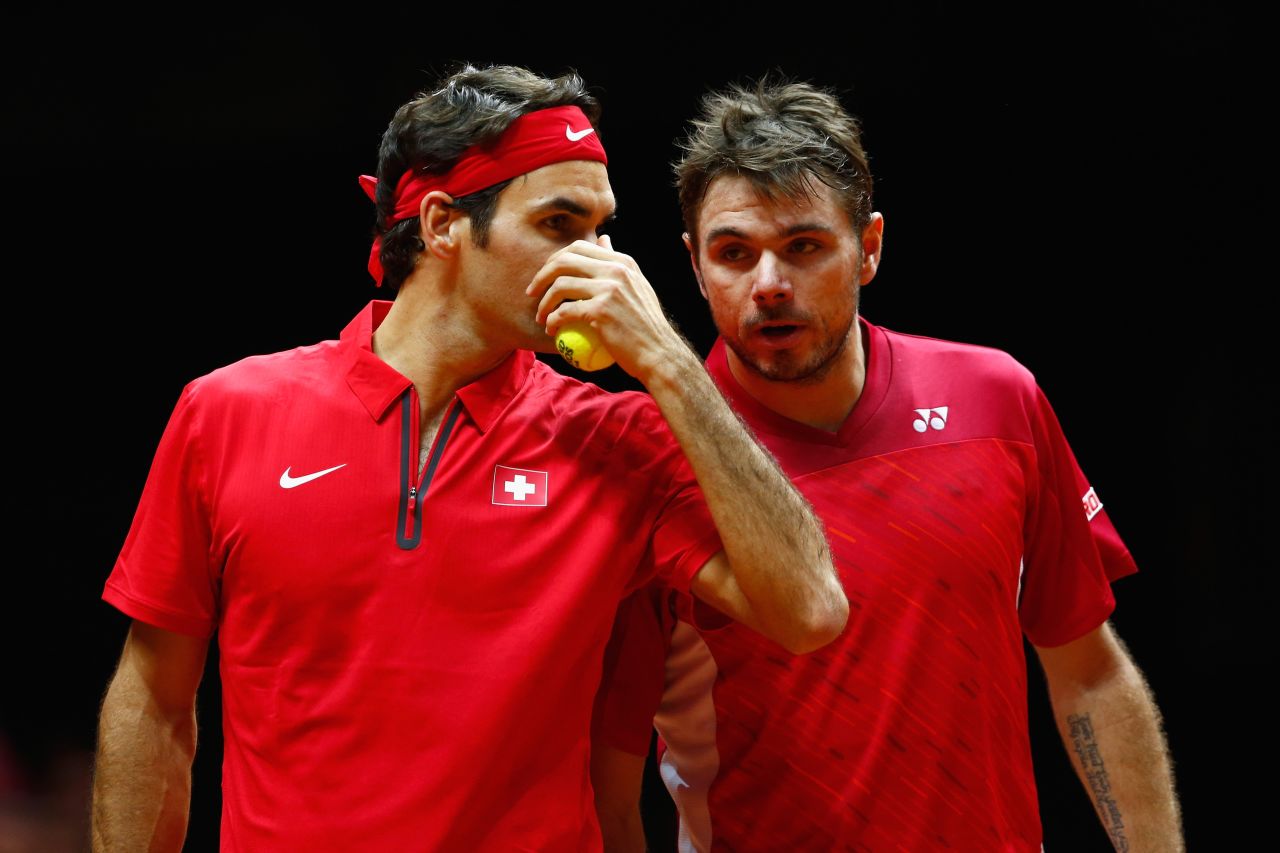 The Swiss pair talk tactics during their doubles match against France's Gasquet and Julien Benneteau.