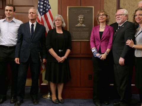 Giffords joins, from left, Ben Zimmerman, Ross Zimmerman, Emily Nottingham, Rep. Ron Barber and Rep. Debbie Wasserman-Schultz during a dedication ceremony on April 16, 2013 for Gabriel Zimmerman, a member of Gifford's staff who was murdered during the January 8 shooting spree. 