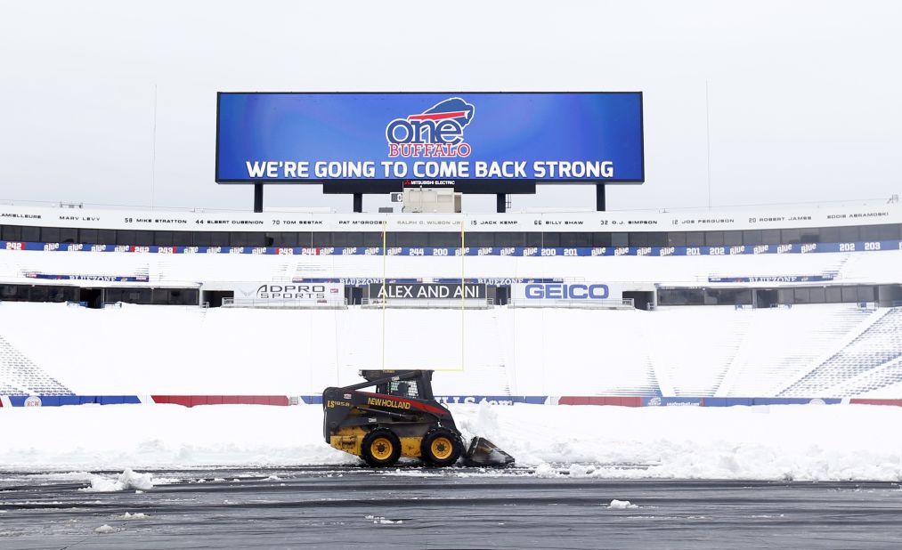 Workers clear snow from the field at Ralph Wilson Stadium on Sunday, November 23 in Orchard Park, New York. Snowed out at the stadium, the Bills are in Detroit to play their "home" NFL football game against the New York Jets on Monday night. Western New York continues to dig out from a lake-effect storm that dumped about a year's worth of snow in three days, trapping residents in their homes and stranding motorists on roadways.
