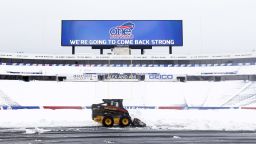 Workers clear snow from the field at Ralph Wilson Stadium on Sunday, Nov. 23, 2014, in Orchard Park, N.Y. Snowed out today at the stadium, the Bills are in Detroit to play their "home" NFL football game against the New York Jets on Monday night, Nov. 24, 2014. (AP Photo/Mike Groll)