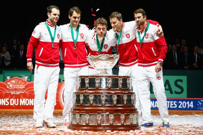 Switzerland got their hands on the Davis Cup for the first time thanks to the efforts of top-10 tennis stars Roger Federer (second left) and Stanislas Wawrinka (center).