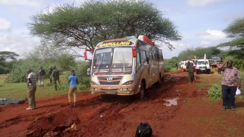 Kenyan security forces and others gather around the scene on an attack on a bus about 50 kilometers (31 miles) outside the town of Mandera, near the Somali border in northeastern Kenya, Saturday, Nov. 22, 2014. Somalia's Islamic extremist rebels, al-Shabab, attacked the bus in northern Kenya at dawn on Saturday, singling out and killing 28 passengers who could not recite an Islamic creed and were assumed to be non-Muslims, Kenyan police said. (AP Photo)