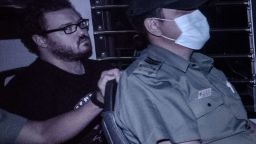 British banker Rurik Jutting, charged with the grisly murders of two women, sits in a prison van as he leaves the eastern court in Hong Kong on November 10, 2014. Jutting had his case adjourned by a Hong Kong court for two weeks of psychiatric reports, as the victims' bodies were due to be flown home to Indonesia. AFP PHOTO / Philippe LopezPHILIPPE LOPEZ/AFP/Getty Images