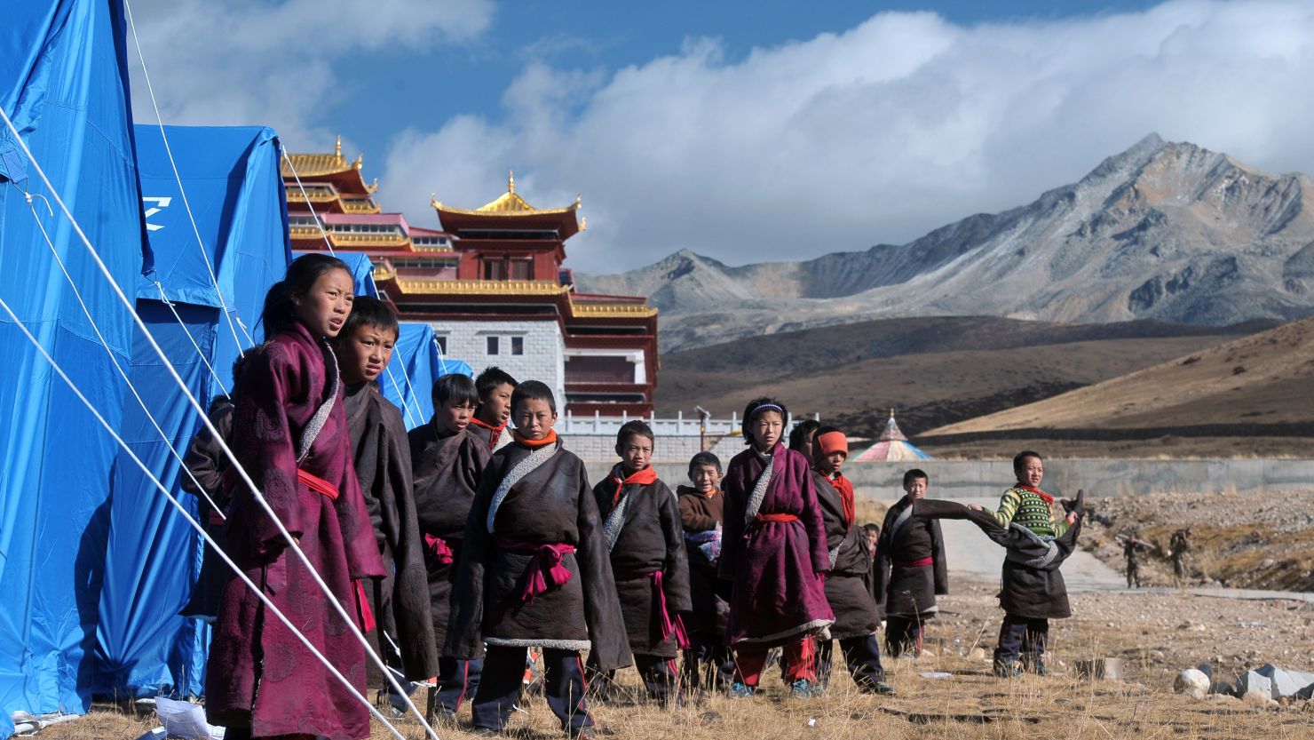 Tibetan youngsters gather outside makeshift tents at a relief center in Kangding on November 23, near where the earthquake struck.