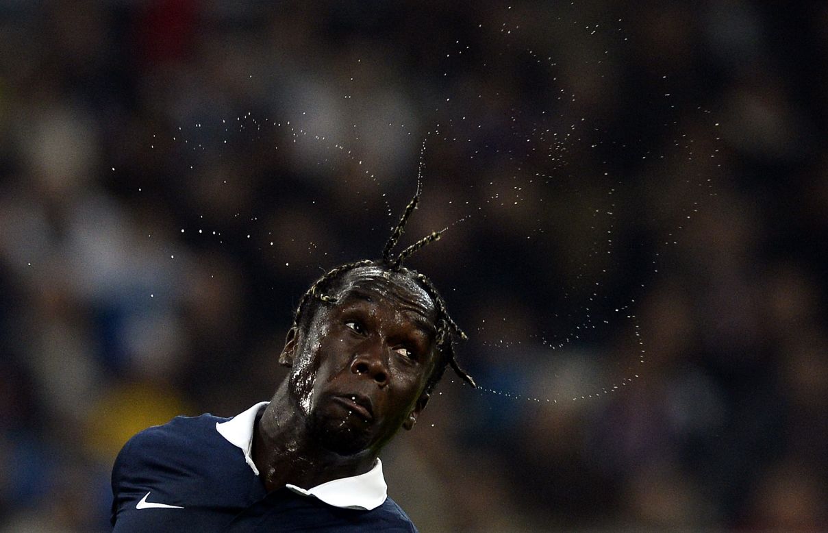 Sweat flies from the head of French defender Bacary Sagna during an international friendly against Sweden on Tuesday, November 18.
