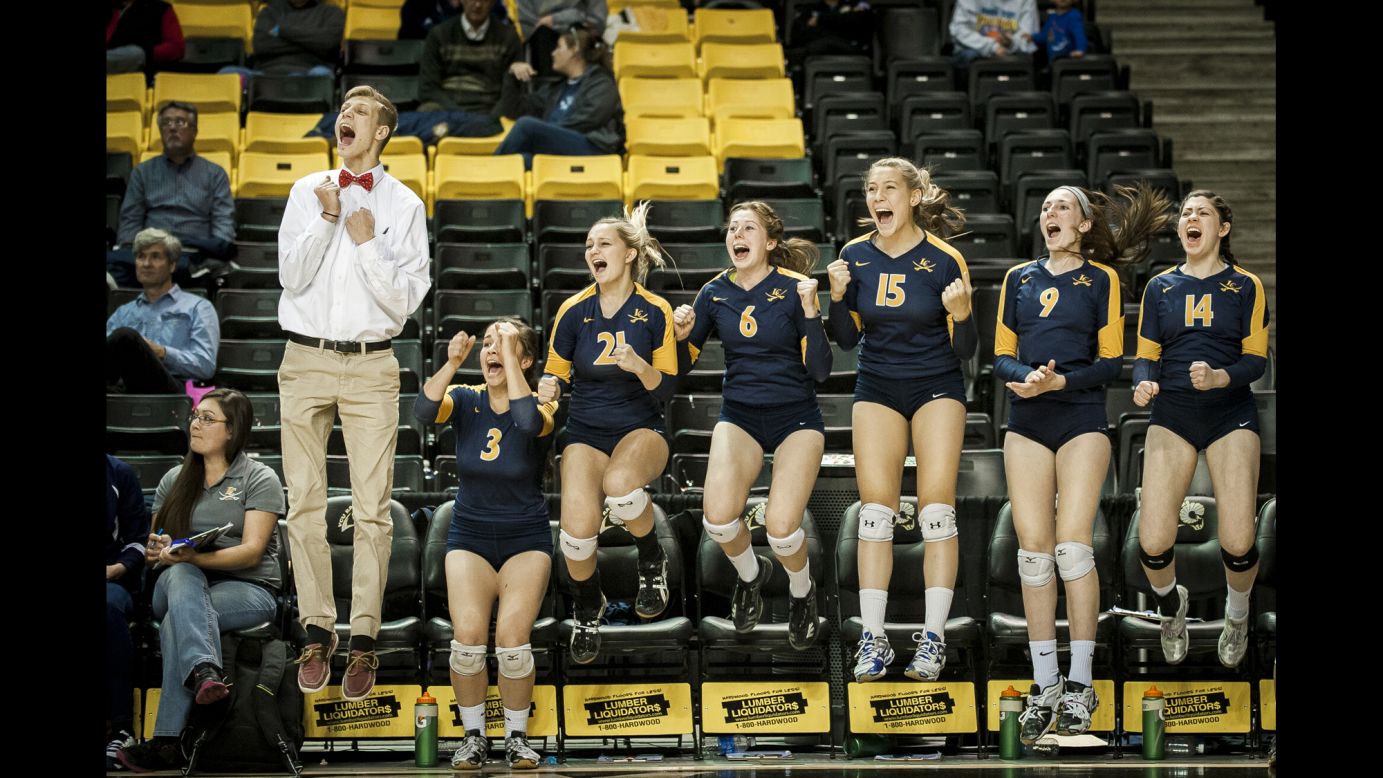 Volleyball players from Loudoun County High School celebrate match point as they defeated James Woods High School to win the Virginia 4A state championship Saturday, November 22, in Richmond, Virginia.