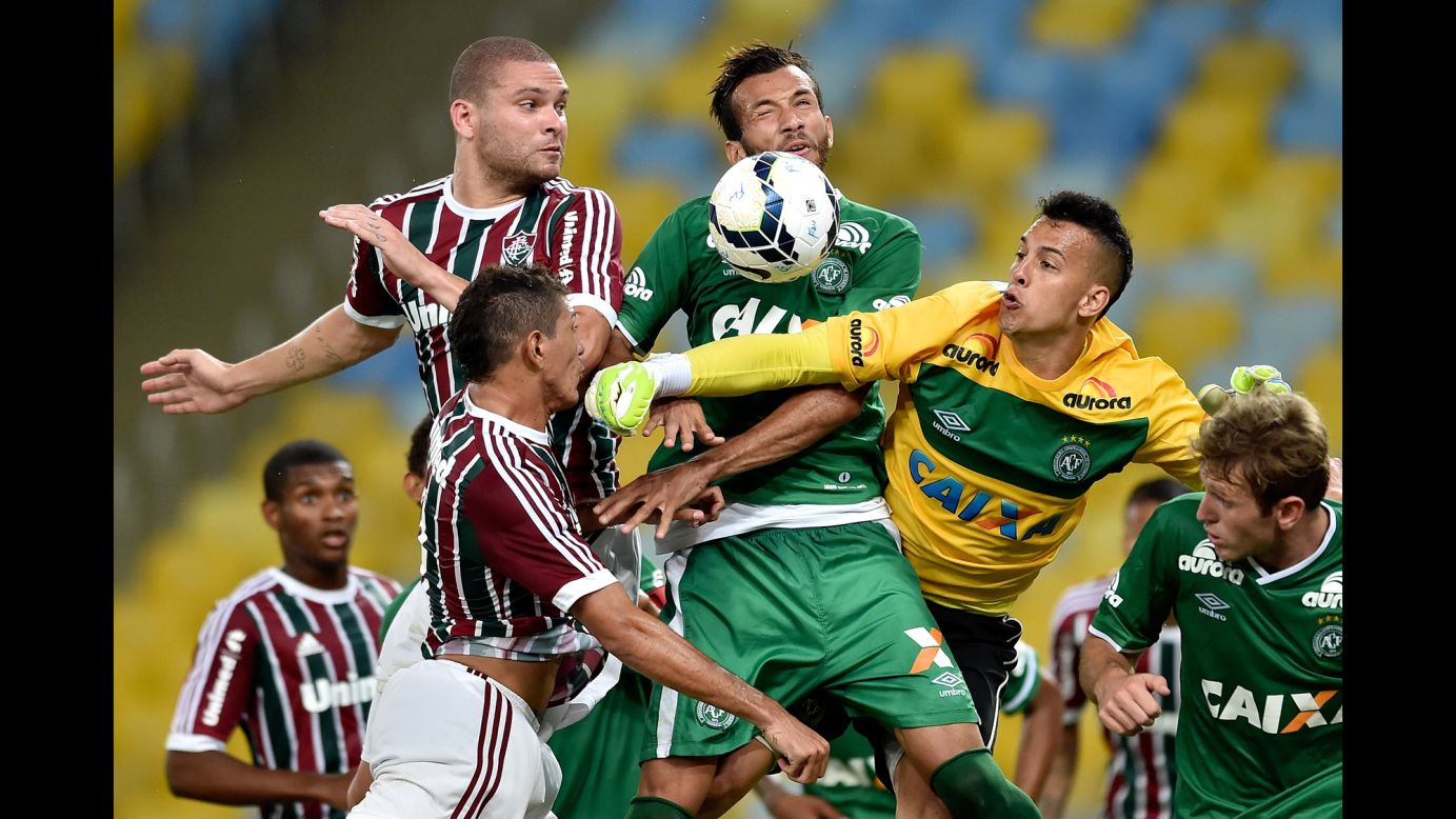 Players from Fluminense and Chapecoense struggle for the ball during a Brazilian league soccer match played Thursday, November 20, in Rio de Janeiro. Chapecoense won 4-1.