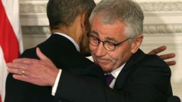 U.S. President Barack Obama (L) hugs Secretary of Defense Chuck Hagel during a press conference announcing Hagel's resignation in the State Dining Room of the White House November 24, 2014 in Washington, DC.