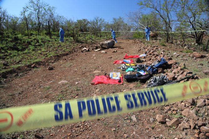 A forensics team searches the area around the body of a poached rhino looking for clues. The rhino was shot along Kruger National Park's border with Mozambique. The investigators have had such a backlog of rhino poaching cases that it has taken them 10 days to get to this one.