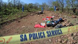 A forensics team searches the area around the body of a poached rhino looking for clues. The rhino was shot along Kruger National Park's border with Mozambique. The investigators have had such a backlog of rhino poaching cases its taken them 10 days before they could get to this one.