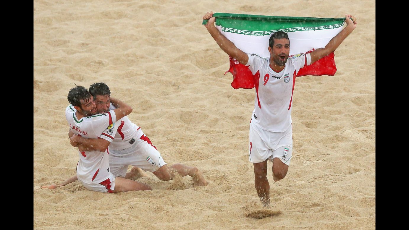 Mohammadali Mokhari, right, and some of his Iranian beach soccer teammates celebrate Friday, November 21, after they defeated Japan to win the gold medal at the Asian Beach Games in Phuket, Thailand.