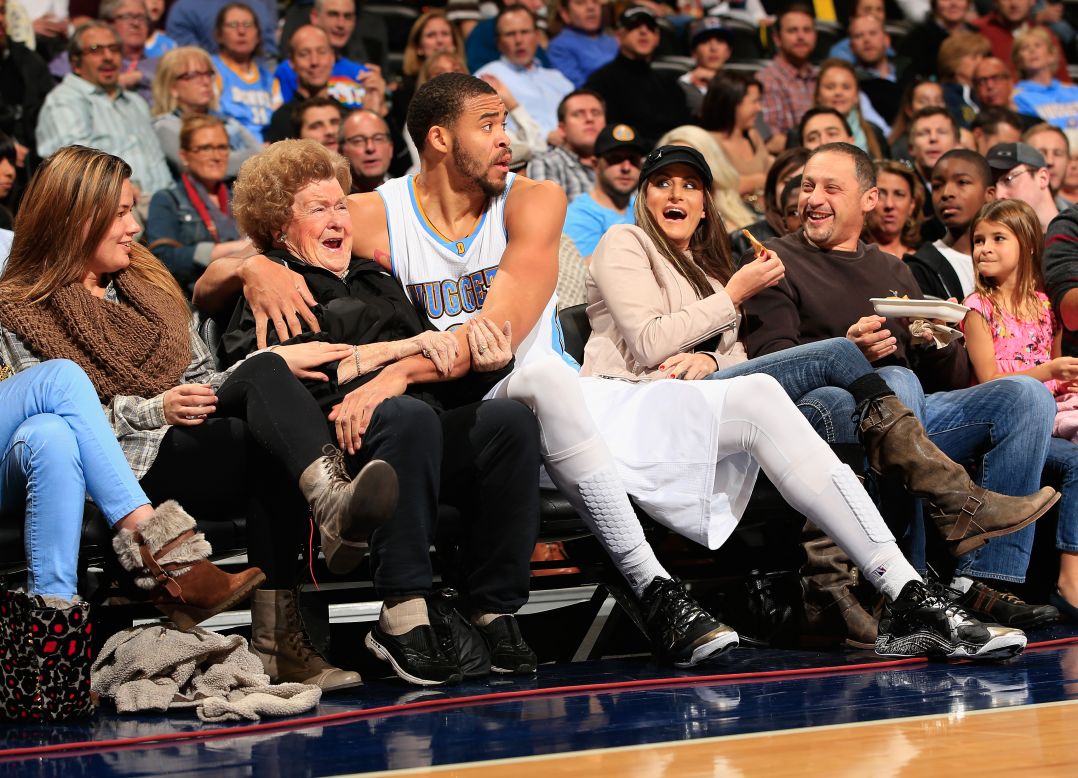 Denver Nuggets center JaVale McGee hugs a fan after he dove into the front row for a loose ball Friday, November 21, in Denver. He also <a href="https://www.youtube.com/watch?v=2NEqYqgpszk" target="_blank" target="_blank">gave the woman a kiss.</a>