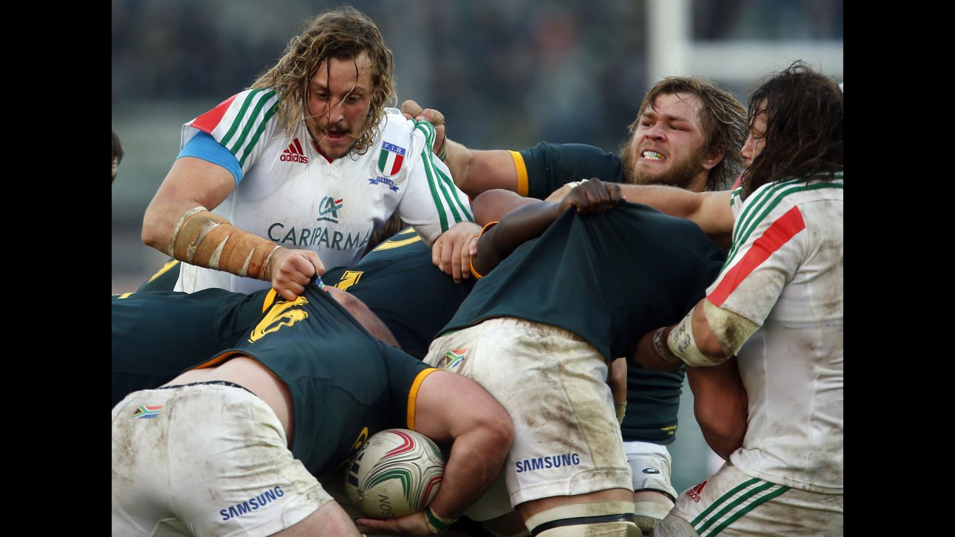 Rugby players from Italy and South Africa fight for the ball during a scrum Saturday, November 22, in Padua, Italy. South Africa won the match 22-6.