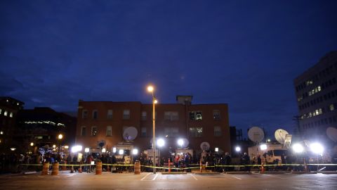 Members of the media line up in a parking lot across from the Buzz Westfall Justice Center on November 24.