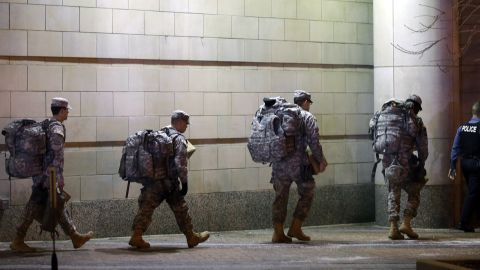 Members of the Missouri National Guard are escorted out of the Buzz Westfall Justice Center. 