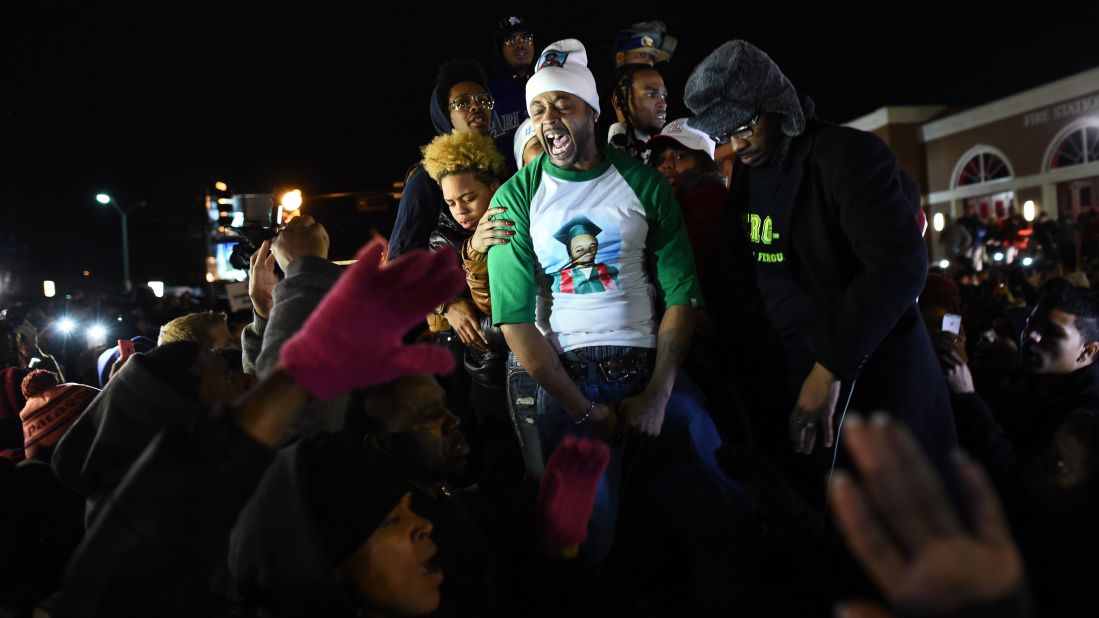 Demonstrators gather outside the police station on November 24.