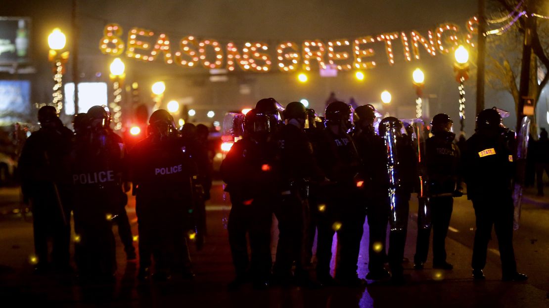 Police in riot gear use tear gas to clear the street in front of the Ferguson, Missouri, Police Department on Monday.