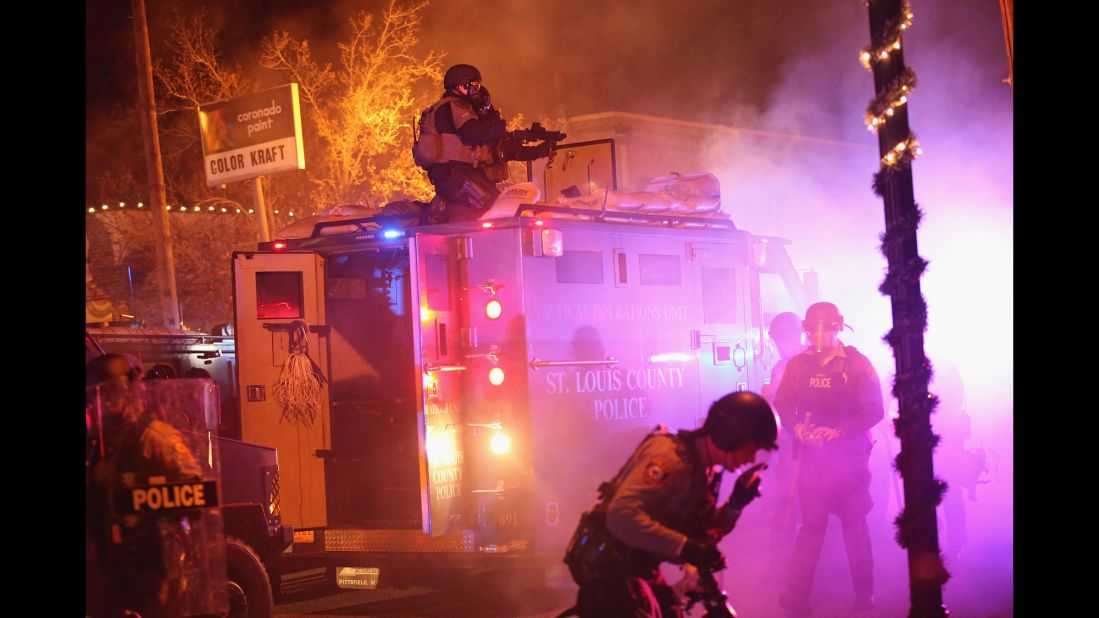 Police confront protesters in Ferguson on November 24.