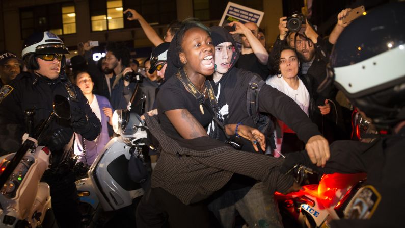 A protester in New York scuffles with police during a march toward Times Square on November 24.