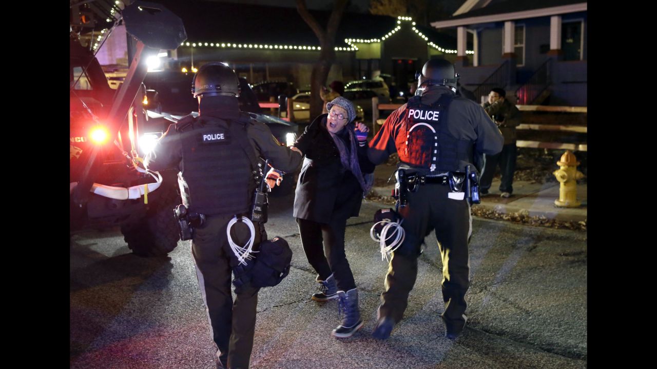 Police officers grab a protester on November 24.