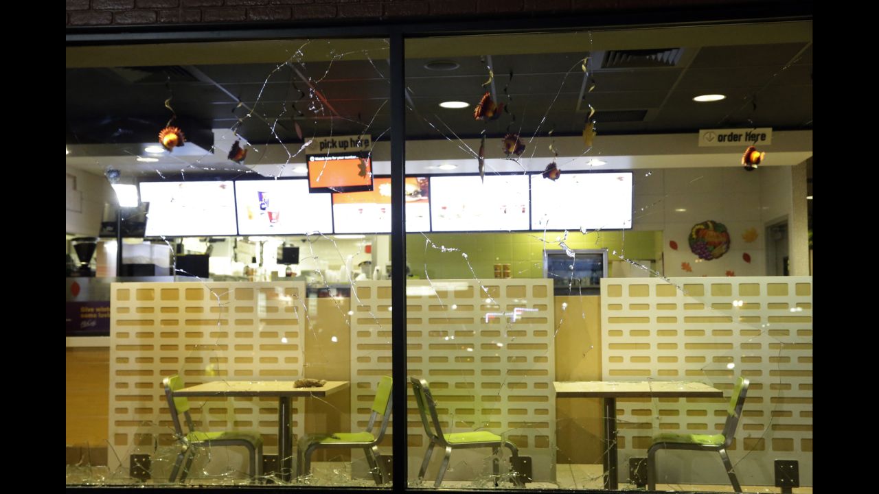 The glass windows of a store are shattered on November 24.