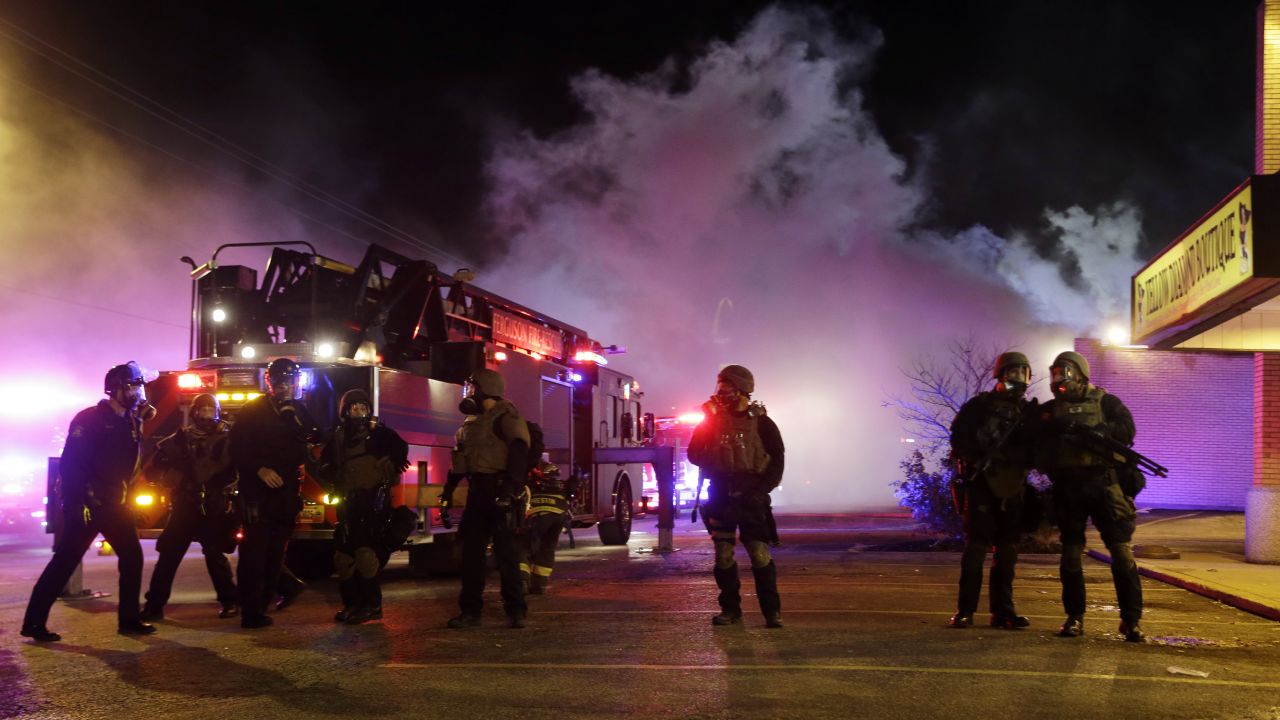 Smoke fills the streets of Ferguson as buildings burn on November 24.