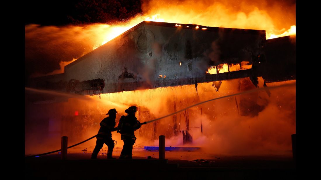 Firefighters work on extinguishing a Little Caesars restaurant on November 24.