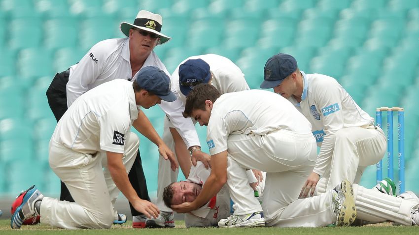 YDNEY, AUSTRALIA - NOVEMBER 25: (EDITORS NOTE: Image contains graphic content.) Phillip Hughes of South Australia is helped by New South Wales players after falling to the ground after being struck in the head by a delivery during day one of the Sheffield Shield match between New South Wales and South Australia at Sydney Cricket Ground on November 25, 2014 in Sydney, Australia. (Photo by Mark Metcalfe/Getty Images) ***BESTPIX***