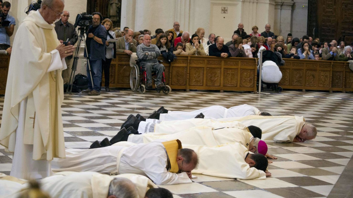 Granada's Archbishop, Francisco Javier Martinez (purple skullcap) prostrates in front of cathedral's high altar to ask forgiveness for 'the scandals.'