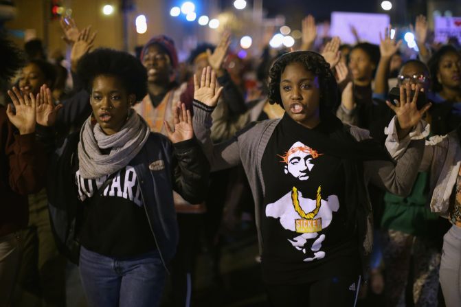 Demonstrators march down a street in Washington on November 24.